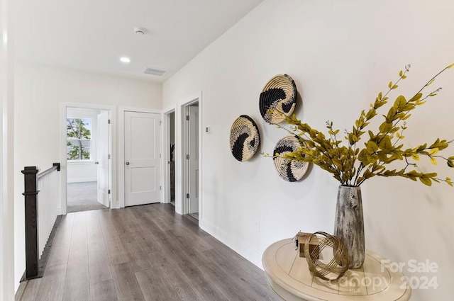 hallway with hardwood / wood-style flooring