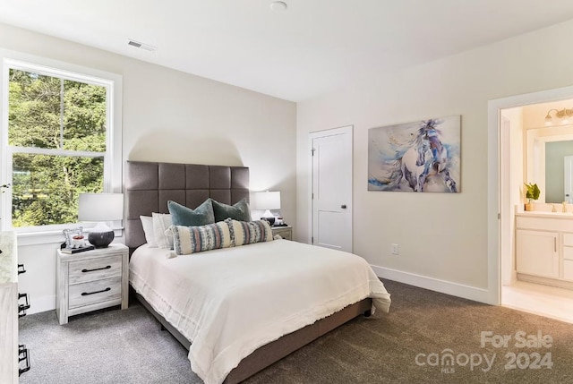 carpeted bedroom with ensuite bathroom