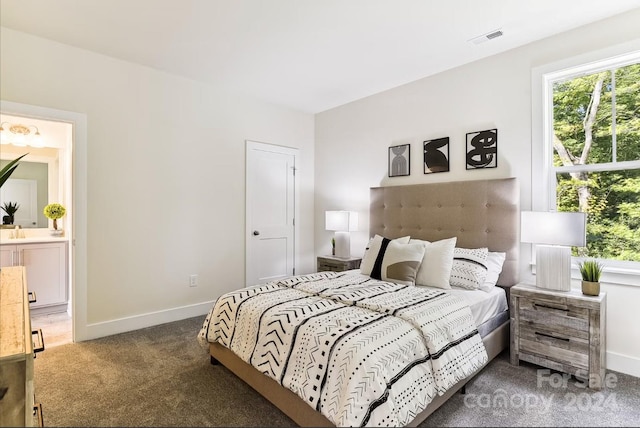 carpeted bedroom with ensuite bath