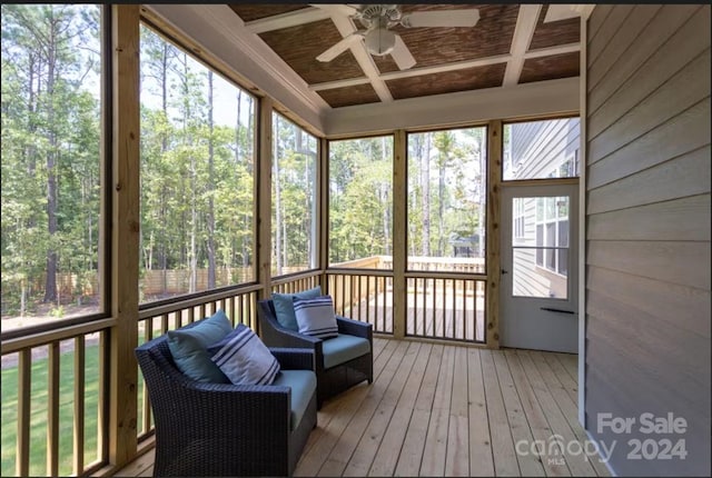 sunroom with ceiling fan and coffered ceiling