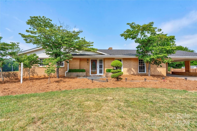 view of front of house with a front lawn and a carport