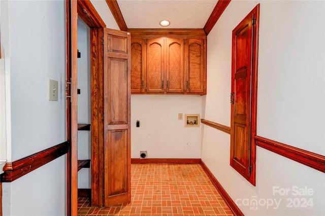 laundry room with cabinets, washer hookup, a textured ceiling, crown molding, and electric dryer hookup