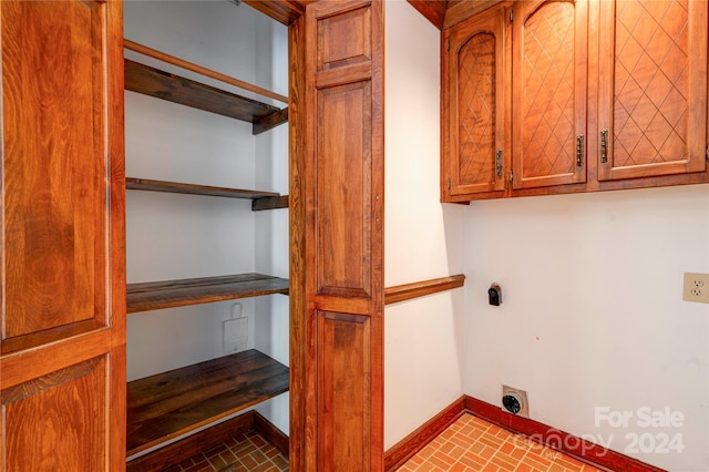 laundry room featuring cabinets and electric dryer hookup