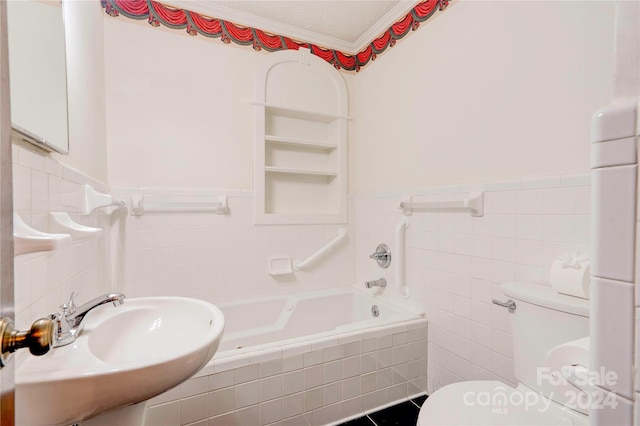 bathroom with built in shelves, crown molding, sink, tile walls, and toilet