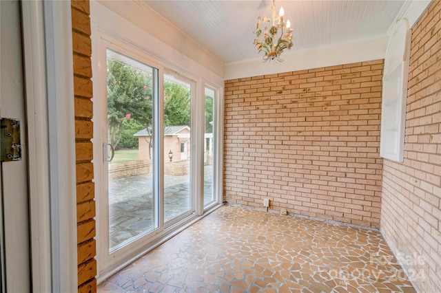 unfurnished sunroom with a chandelier