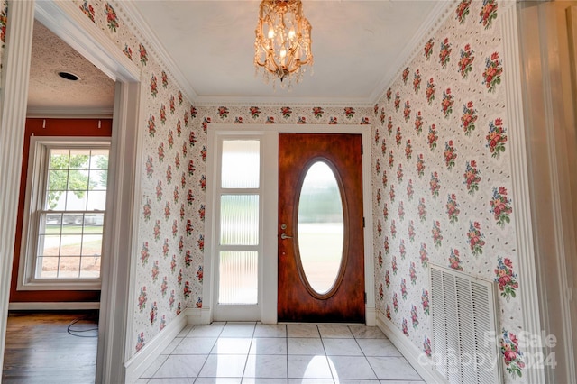 entrance foyer with crown molding, light tile patterned floors, and a notable chandelier