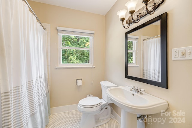 bathroom with toilet, sink, tile patterned floors, and a shower with shower curtain