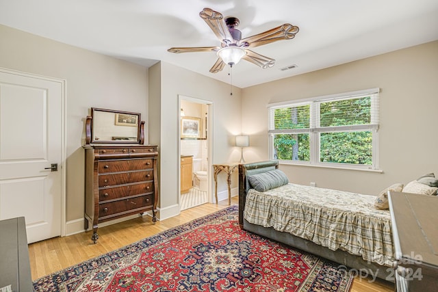 bedroom featuring connected bathroom, light hardwood / wood-style floors, and ceiling fan