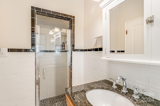 bathroom featuring vanity, walk in shower, and tile walls