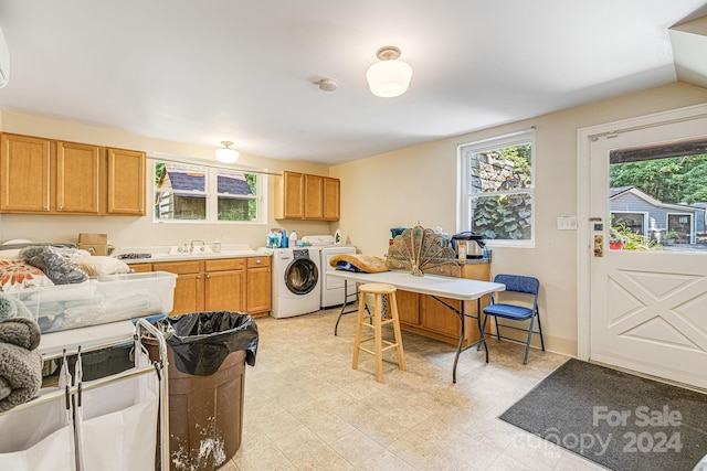 kitchen with lofted ceiling, sink, and separate washer and dryer