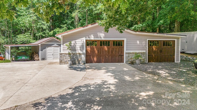 exterior space featuring a garage and an outbuilding