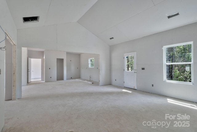 unfurnished room with high vaulted ceiling and visible vents