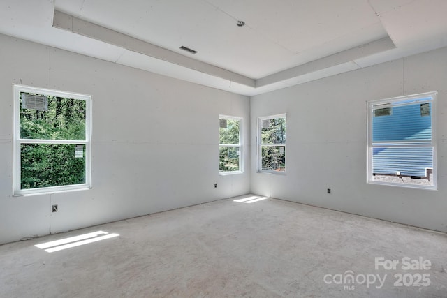 empty room with visible vents and a raised ceiling