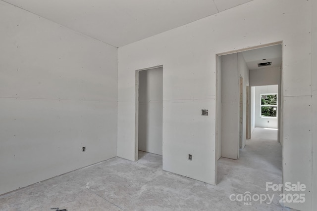 spare room featuring visible vents and unfinished concrete flooring