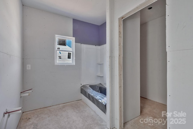 bathroom featuring a tub and concrete floors