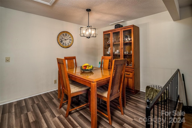 dining room with a notable chandelier, a textured ceiling, and dark hardwood / wood-style floors