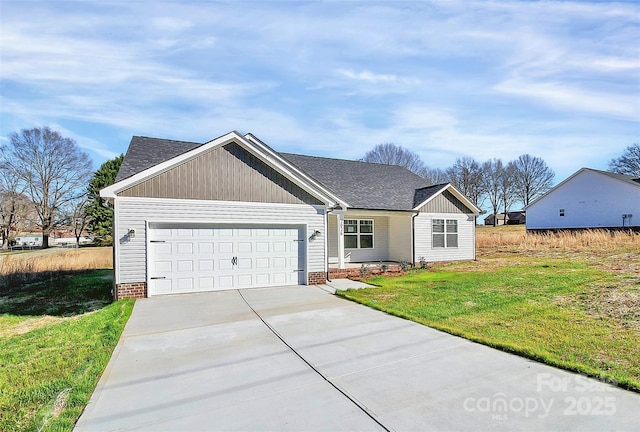 view of front of home with a front yard and a garage