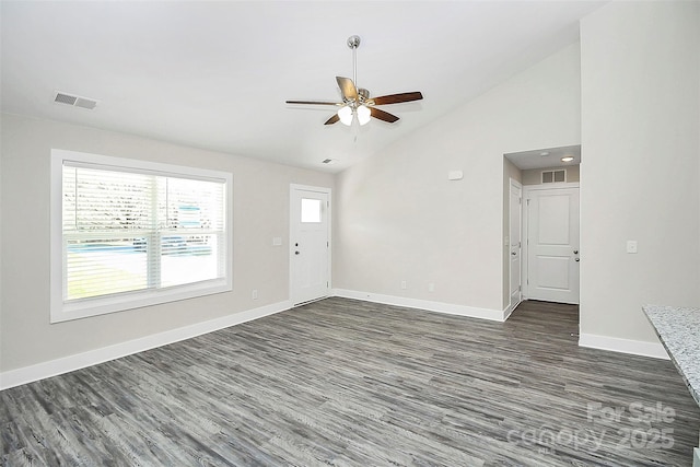unfurnished living room featuring dark wood-style floors, baseboards, visible vents, lofted ceiling, and ceiling fan