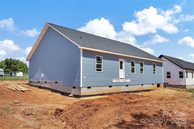 rear view of property featuring crawl space