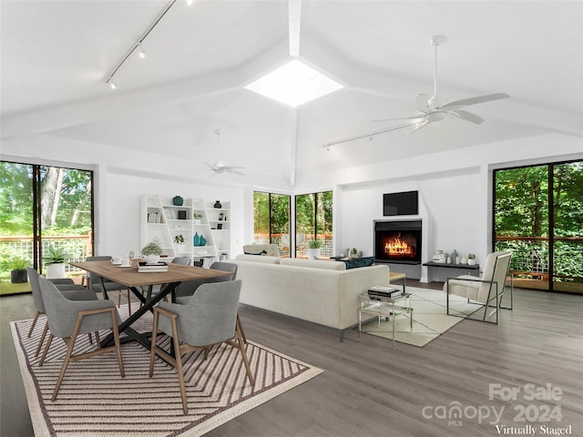 dining area with ceiling fan, wood-type flooring, and lofted ceiling