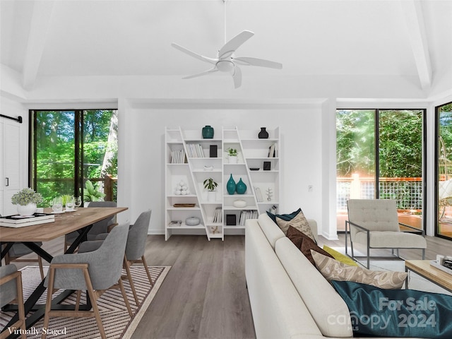 living room with ceiling fan, vaulted ceiling with beams, and wood-type flooring