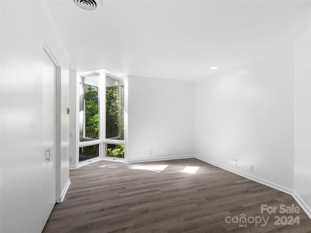 spare room with dark hardwood / wood-style floors