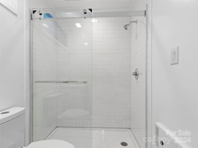 bathroom with toilet and an enclosed shower