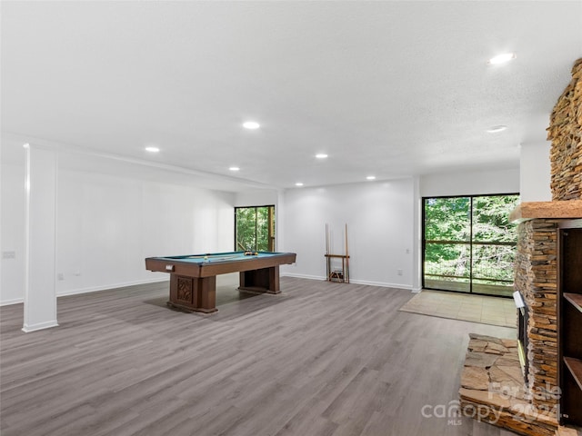 recreation room with a textured ceiling, wood-type flooring, and billiards