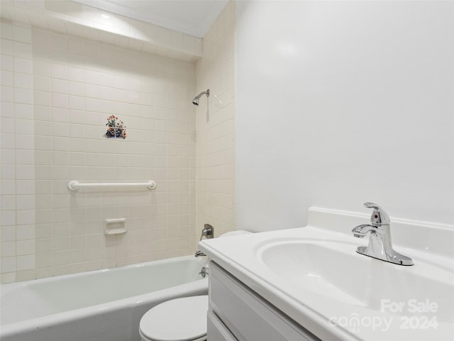 full bathroom with toilet, tiled shower / bath, and vanity