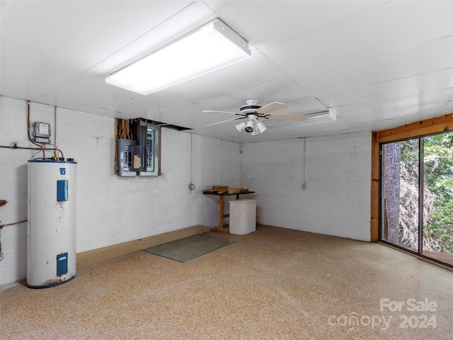 basement with ceiling fan, electric water heater, and electric panel