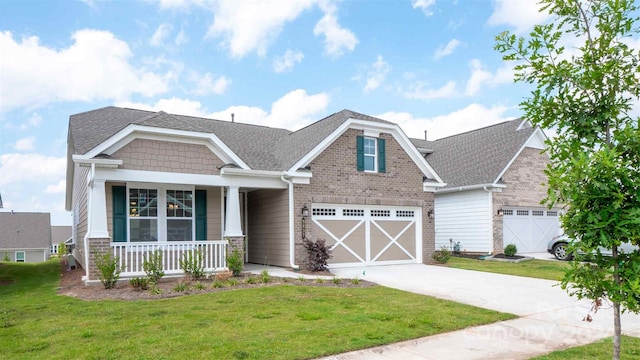 craftsman-style home with a porch, a garage, and a front yard