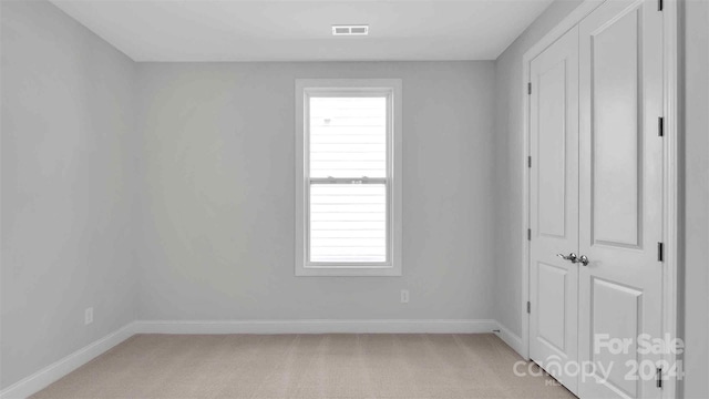 unfurnished bedroom featuring light colored carpet