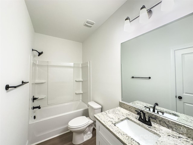 full bathroom with toilet, hardwood / wood-style flooring, shower / washtub combination, and vanity