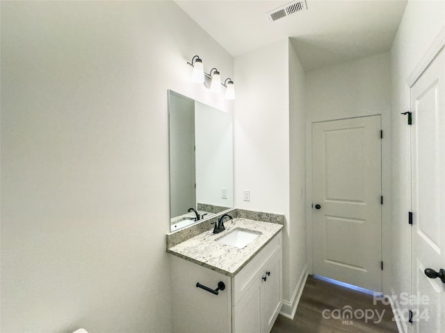 bathroom featuring hardwood / wood-style floors and vanity