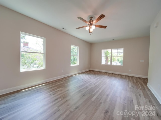 empty room featuring ceiling fan and light wood-type flooring