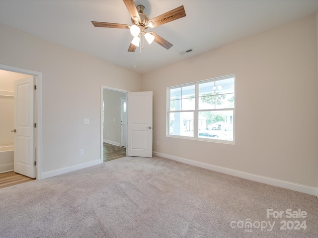 unfurnished bedroom featuring light carpet and ceiling fan