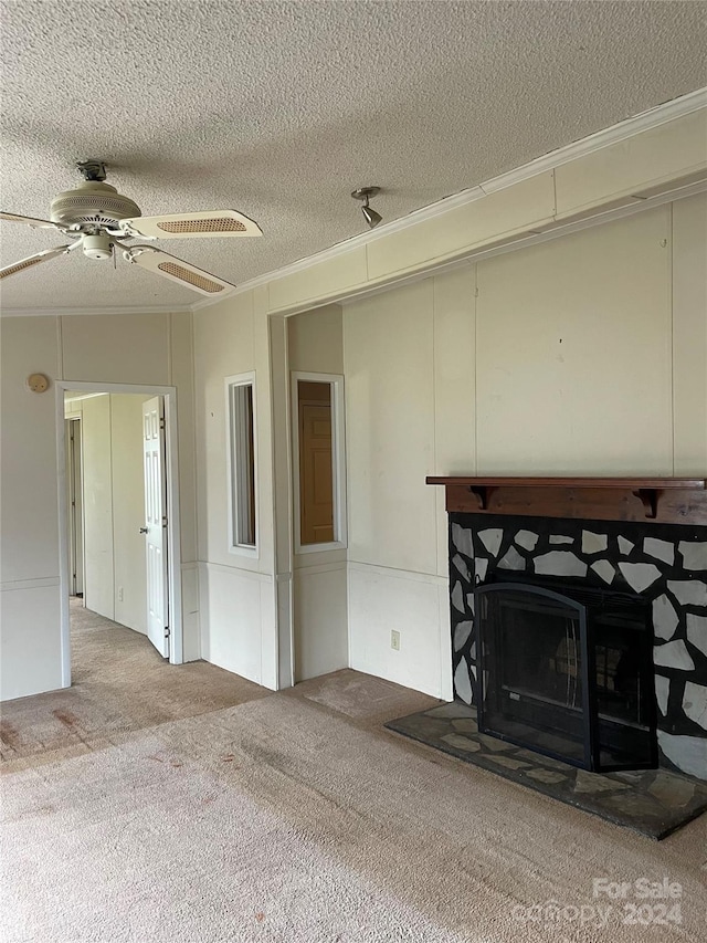 unfurnished living room featuring carpet flooring, a textured ceiling, ceiling fan, and crown molding