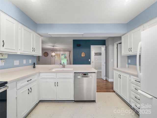 kitchen featuring sink, stainless steel dishwasher, white cabinets, and white fridge