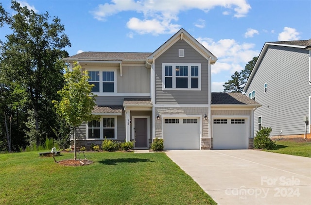 view of front of home with a front lawn and a garage