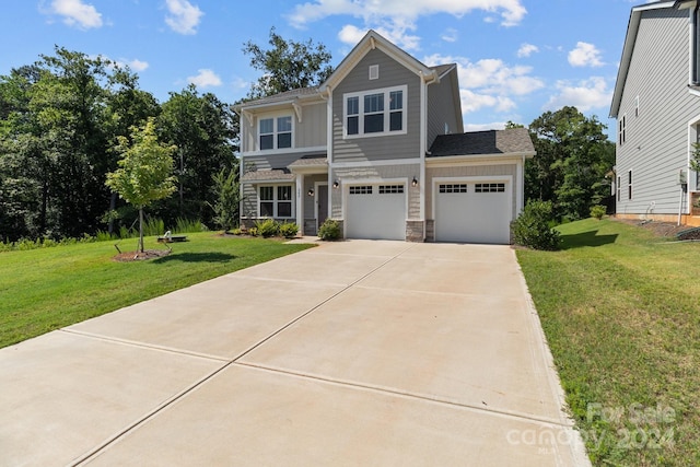 view of front of house with a garage and a front lawn