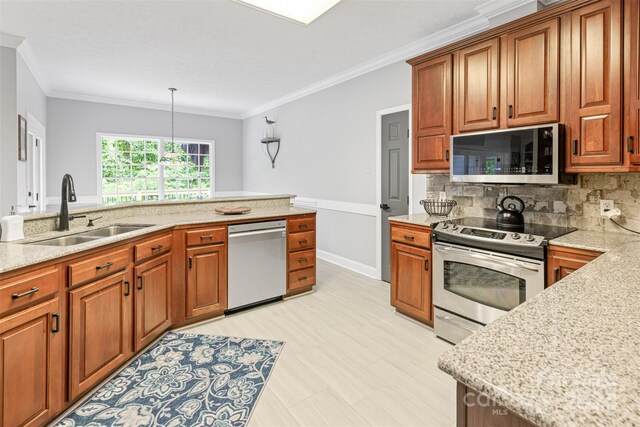 kitchen featuring decorative light fixtures, backsplash, sink, stainless steel appliances, and ornamental molding