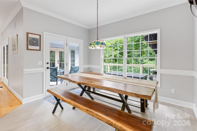 dining room featuring ornamental molding and french doors