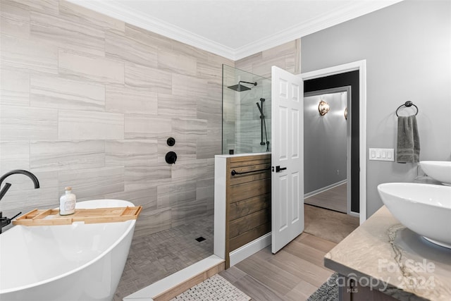 bathroom featuring ornamental molding, shower with separate bathtub, and vanity