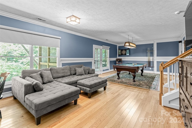 living room featuring hardwood / wood-style flooring, ornamental molding, a textured ceiling, and billiards