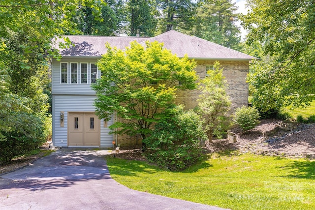 view of front facade with a front lawn and a garage