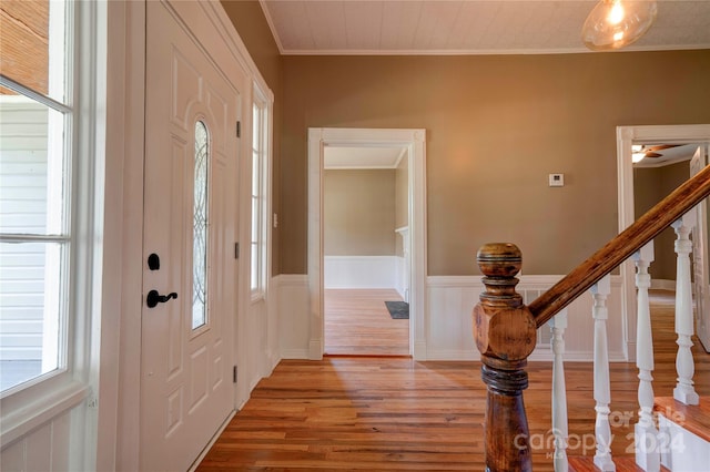 entryway featuring light hardwood / wood-style floors and crown molding