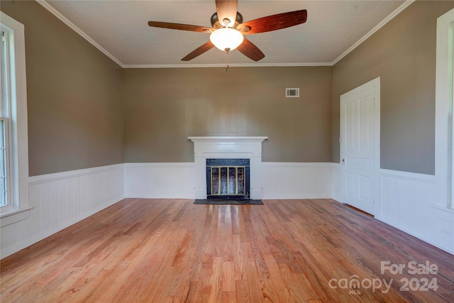 unfurnished living room with ceiling fan, crown molding, and hardwood / wood-style flooring