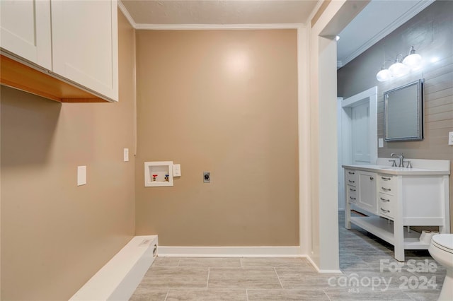 laundry area featuring hookup for a washing machine, sink, ornamental molding, and hookup for an electric dryer