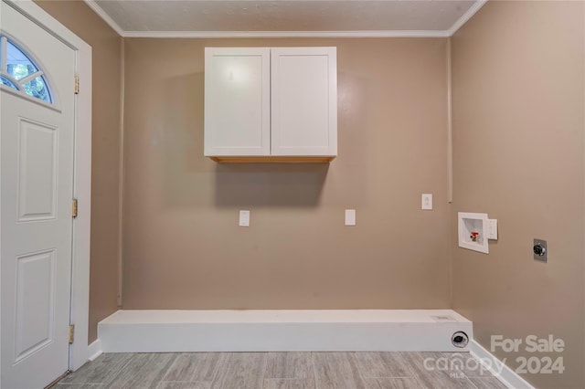 clothes washing area with washer hookup, hookup for an electric dryer, crown molding, and cabinets