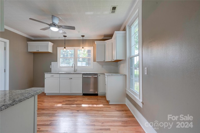 kitchen with stainless steel dishwasher, decorative backsplash, sink, and white cabinetry